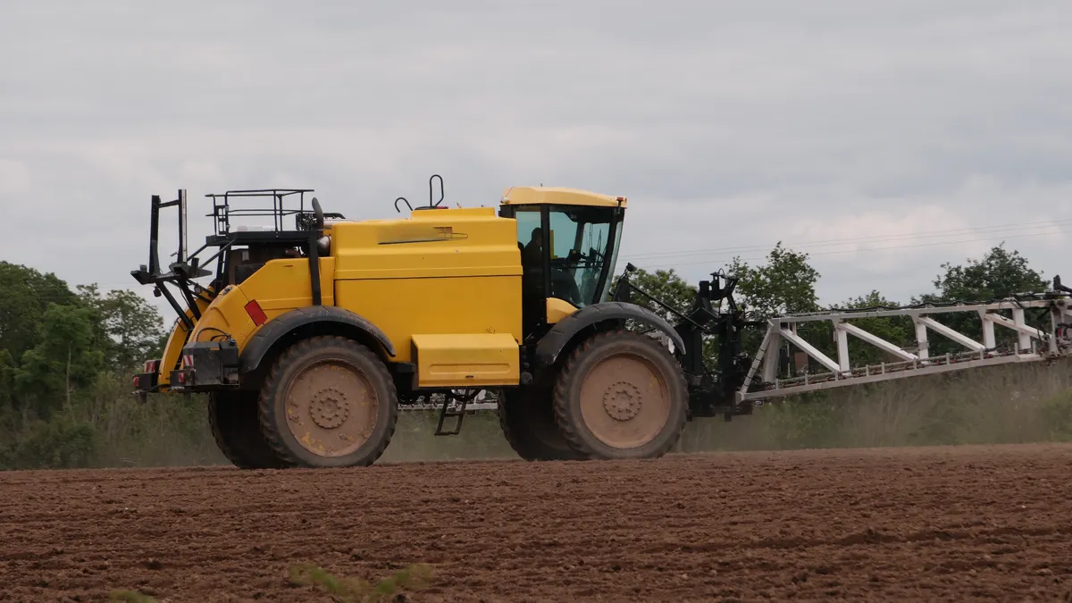 Large agricultural spray truck in a field