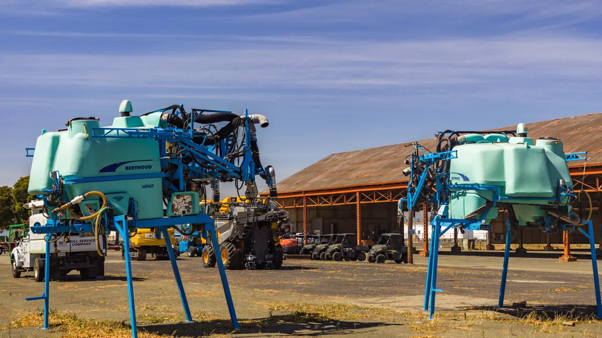 Farm sprayer equipment in an open yard